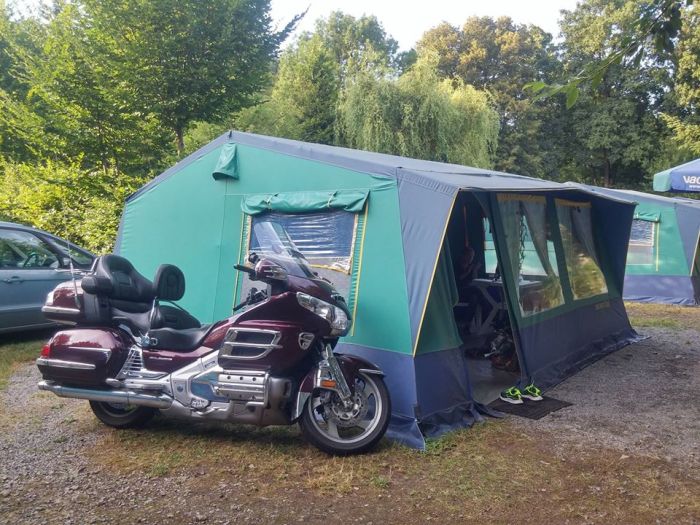 Honda Goldwing motorcycle near big camping tent